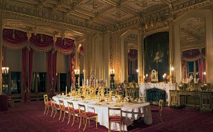 In the State Dining Room the 9ft antique table with its 100-year-old tablecloth has been set for Christmas dinner for 14 people